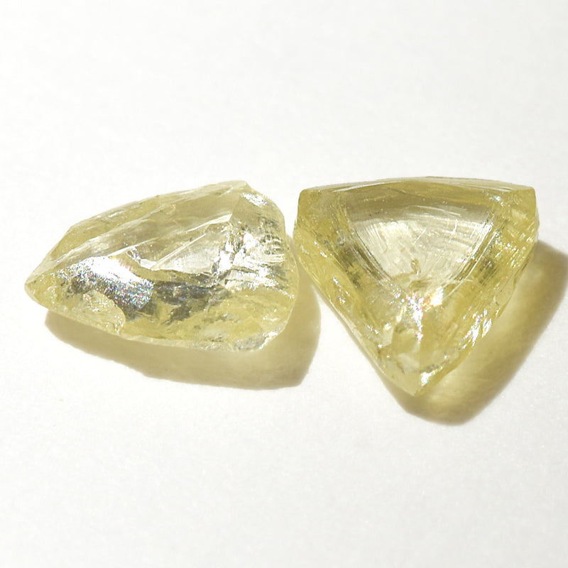 0.48 carat fancy yellow triangular rough diamond pair