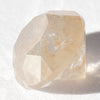 0.64 carat champagne colored round brilliant rough cut diamond