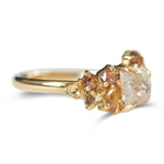 Raw diamond with clustered golden raw diamonds in yellow gold