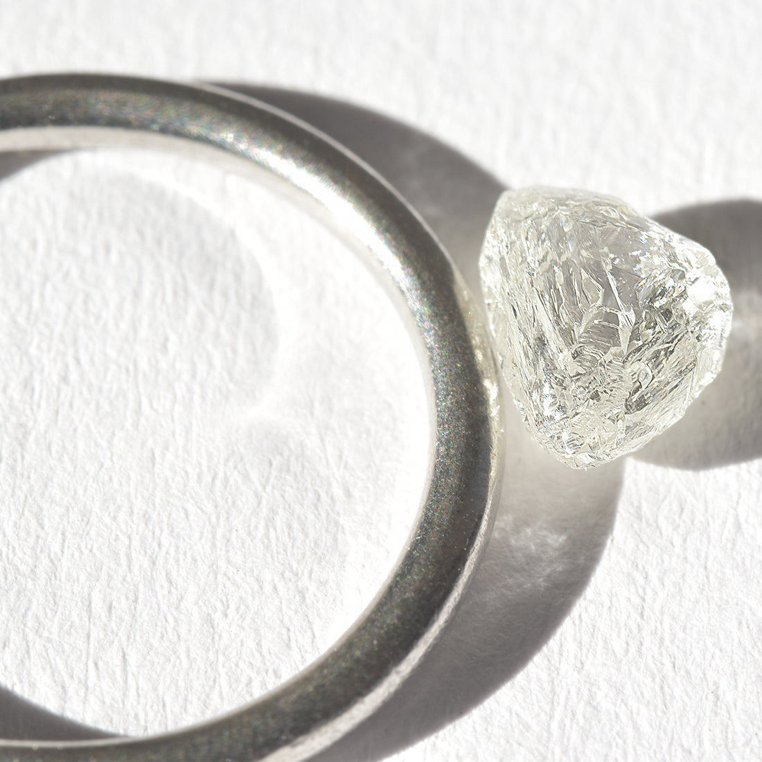 1.21 carat white and glowy triangular raw diamond