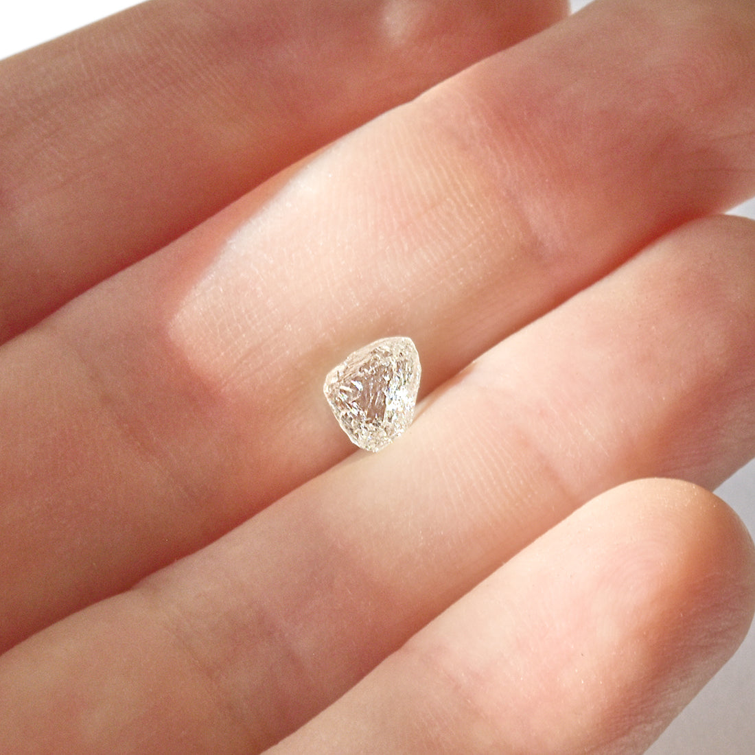 1.21 carat white and glowy triangular raw diamond