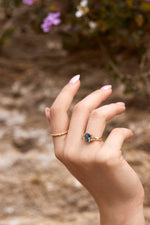 Blue cushion cut sapphire engagement ring with baguette sidestones with matching twig band