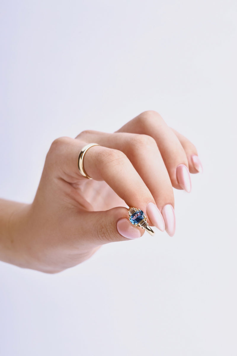 Blue sapphire engagement ring with baguette diamond sidestones