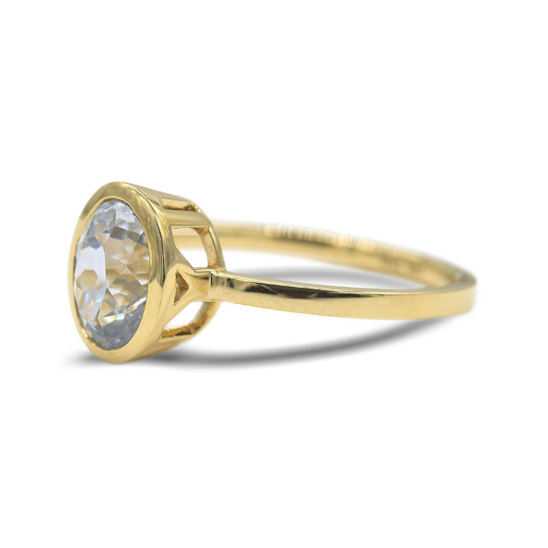 Ethereal white sapphire bezel set ring in 14k yellow gold