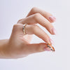 raw diamond wedding bands on model hands