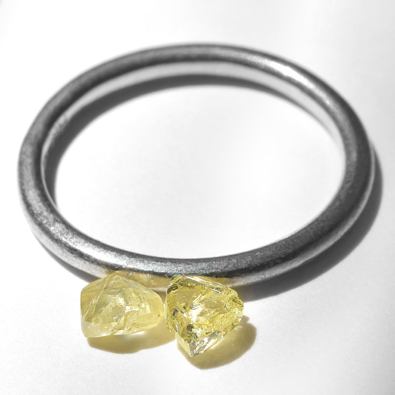 0.66 carat fancy yellow triangular rough diamond pair