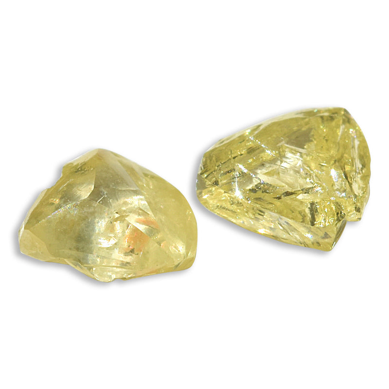 0.66 carat fancy yellow triangular rough diamond pair
