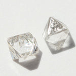 0.72 carat silver white raw diamond octahedron pair