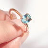 Cushion cut teal sapphire engagement ring in rose gold