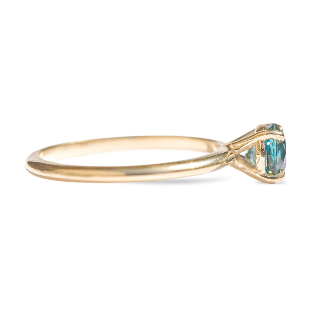 Montana sapphire teal sapphire engagement ring in a delicate band 14k yellow gold size 6 and ready to ship. Ethically sourced from Montana USA.