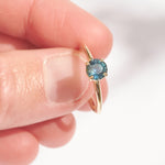 Montana sapphire teal sapphire engagement ring in a delicate band 14k yellow gold size 6 and ready to ship. Ethically sourced from Montana USA.