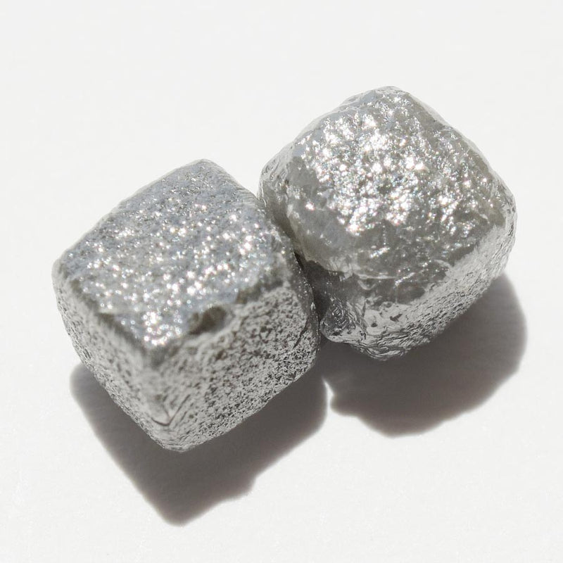 4.72 carat silver gray cubical raw diamond pair