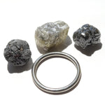 24.36 carat white, black and gray raw diamond parcel