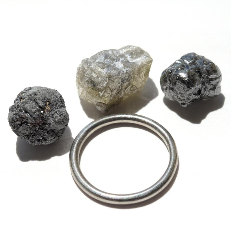 24.36 carat white, black and gray raw diamond parcel