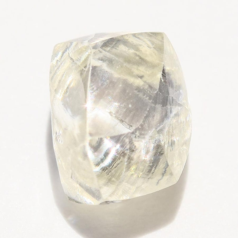 0.74 carat waterlike and yellow greenish rough diamond dodecahedron