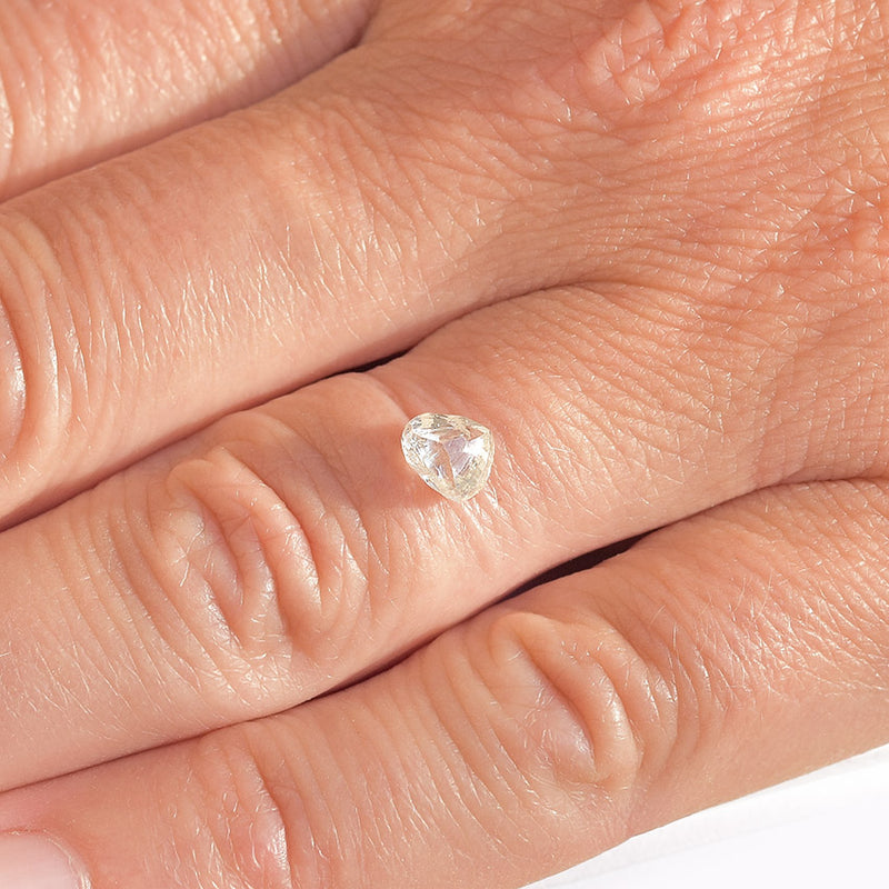 pear shaped raw diamond on a finger