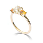 The Keren ring model - a rough diamond engagement ring with two bright apricot sapphires