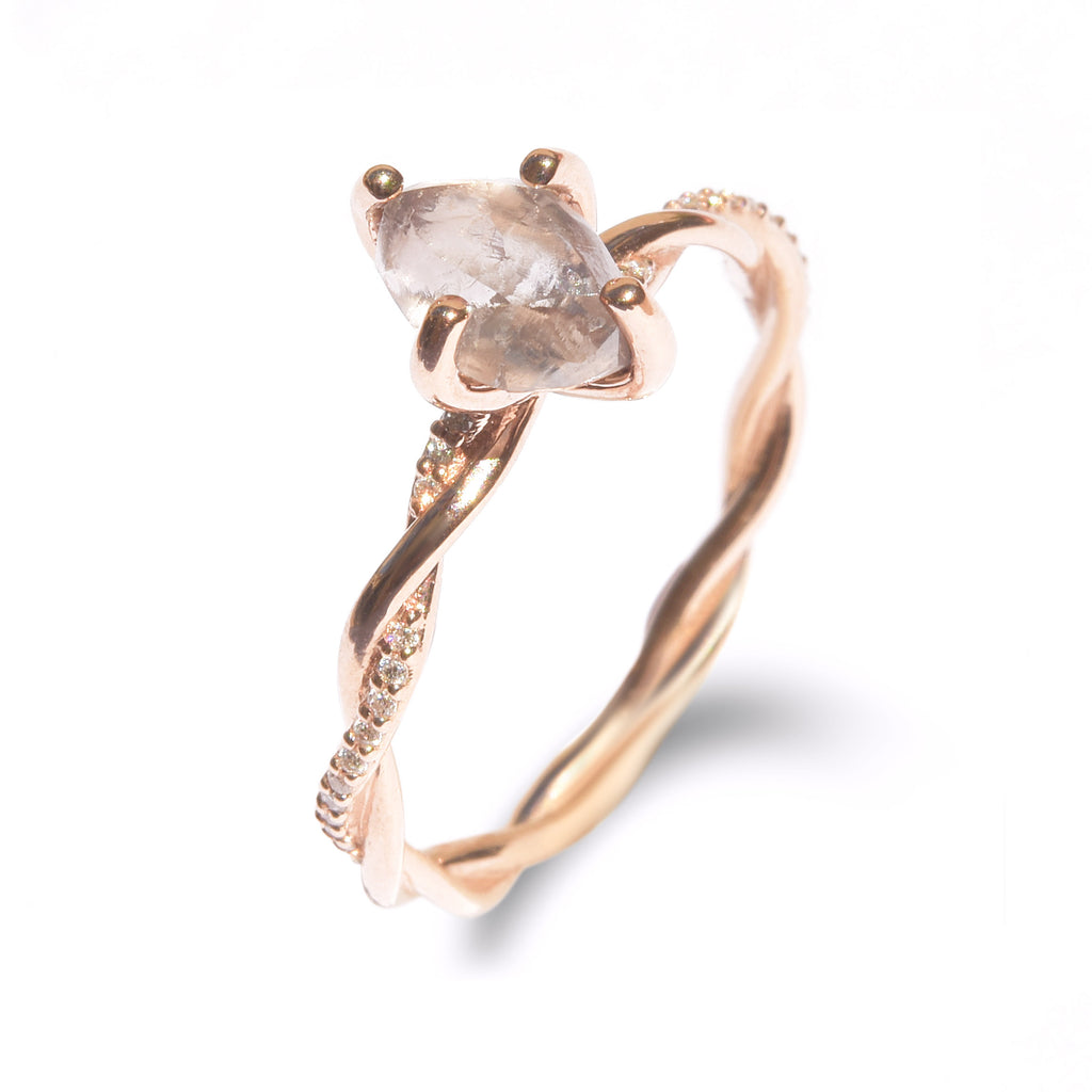 The Gefen ring - a raw diamond engagement ring with a twisted gold band with inlaid cut diamonds.