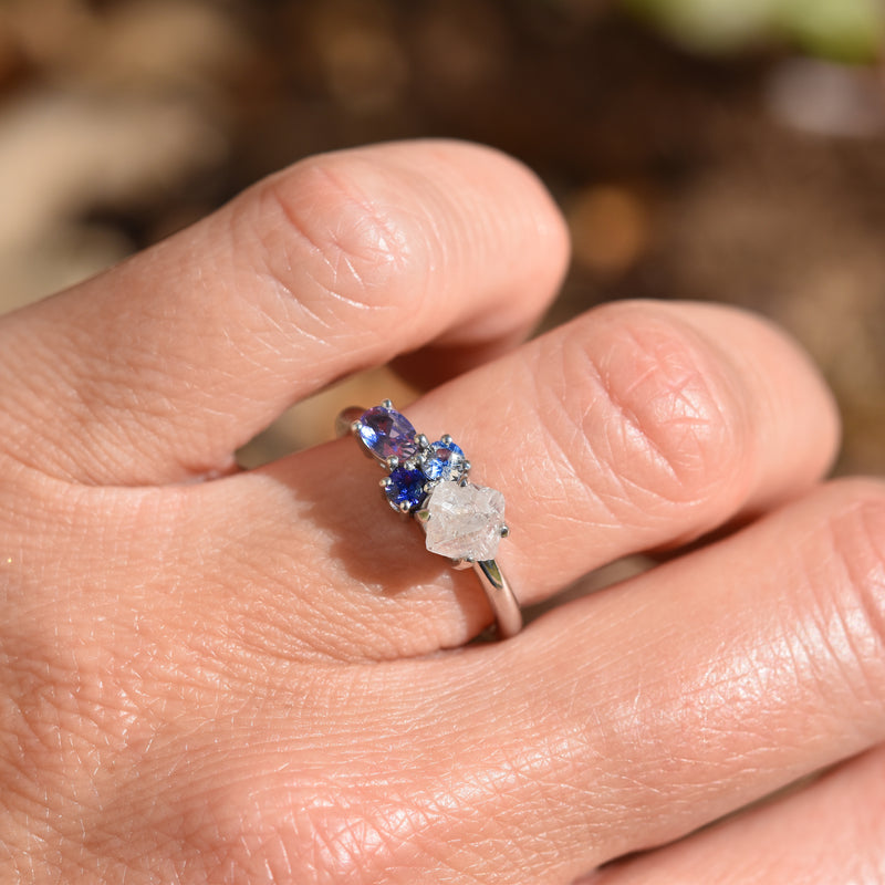 Raziel ring - a customizable rough diamond and sapphire cluster engagement ring on a hand