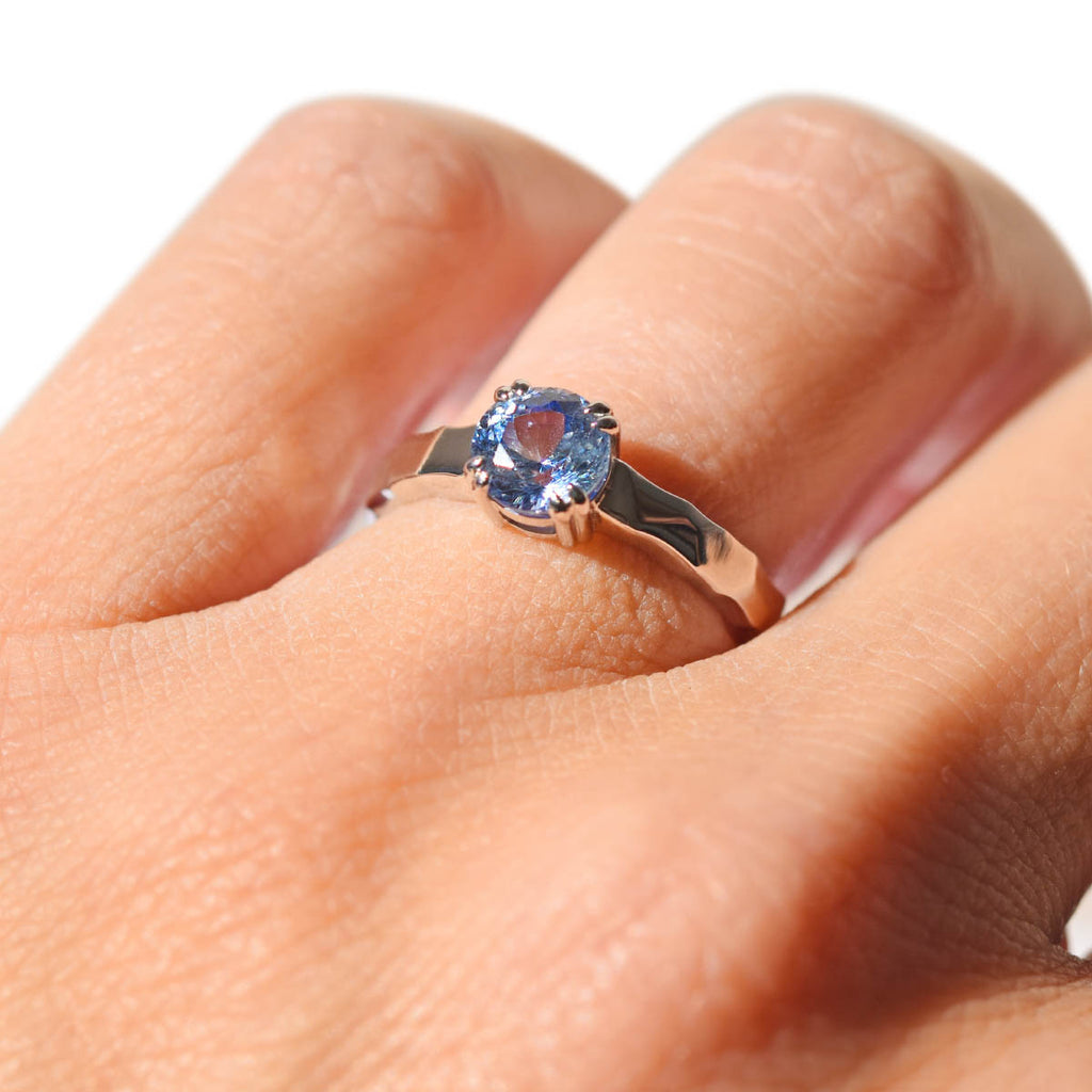 Ice blue sapphire solitaire engagement ring with double prongs and hammered band