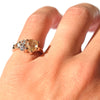 Raziel ring - a customizable rough diamond and sapphire cluster engagement ring with golden raw diamond on a hand model