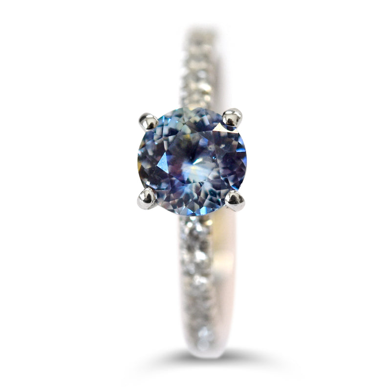 A sapphire engagement ring with four prongs and diamond melee on the band