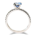 A sapphire engagement ring with four prongs and diamond melee on the band
