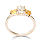 The Keren ring model - a rough diamond engagement ring with two bright apricot sapphires